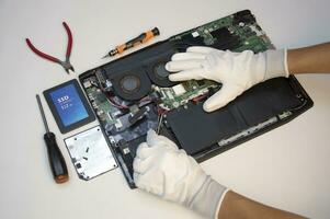 Top view. Technician repairing notebook computer, repairing motherboard and circuit. photo