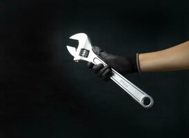 Mechanic holding a large adjustable wrench Size 375 mm photo