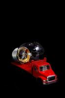 a red truck with a light bulb on top photo