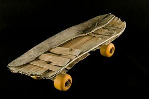 a skateboard made from old wood and yellow wheels photo