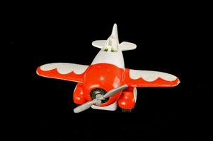 a toy airplane is shown on a black background photo