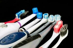 a group of different types of toothbrushes photo