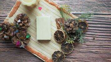 Homemade natural soap bar and dry flower on black background video