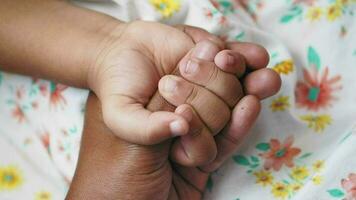 father holding hand of baby child, video