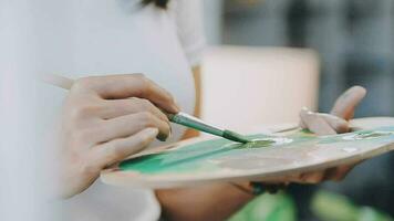 Attractive young woman attending a painting workshop, having fun, create an inspired art work at art studio video