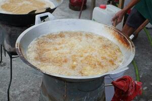 Cooking oil boiling on a pan is frying snacks photo