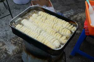 Potato snacks skewered with bamboo and then fried in hot oil are often sold at culinary festivals photo