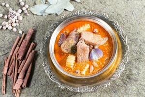 Traditional creamy red Thai pork curry recipe photo