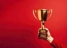 Front view of metallic golden goblet with copy space isolated red background AI generated photo