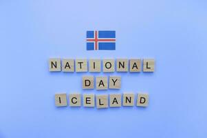 December 1, Independence Day in Iceland, flag of Iceland, minimalistic banner with wooden letters on a blue background photo