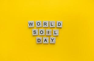December 5, World Soil Day, minimalistic banner with the inscription in wooden letters photo