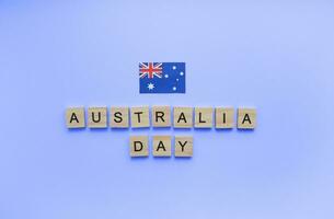 January 26, Australia Day, flag of Australia, minimalistic banner with wooden letters on a blue background photo