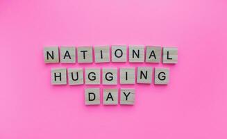 January 21, National Hugging Day, National Hug Day, minimalistic banner with the inscription in wooden letters photo