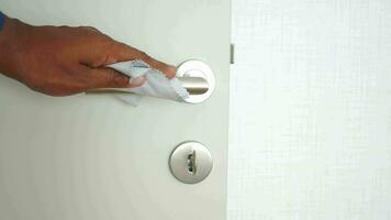 cleaning door knob with tissue close up video