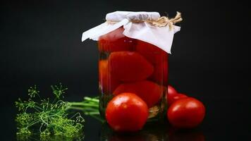 Cooked homemade tomato juice canned in a jar of natural tomatoes. video