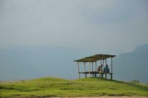 Sunrise on the tiny hut on top of the hill, Foggy sky view, mind-blowing beauty of nature. 3d artwork photo