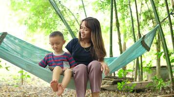 Mother and son sitting and talking video