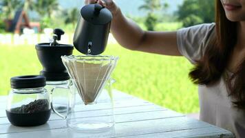 Woman pours hot water into coffee filter video