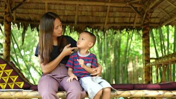 Mother and son sitting and talking video