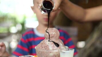 Mom gives ice cream to son to eat. video