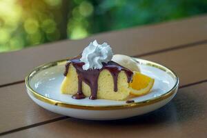 Cocoa Cotton Cake is a cake with a strong cream cheese flavor. The texture is soft and light, similar to chiffon. Gently top the cake with cocoa, serve with ice cream and decorate with orange petals. photo