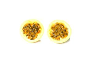 isolated passion fruit on white background. The passion fruit has an oval shape, a thick, oily rind. There are many seeds inside the fruit. It is a healthy fruit with high fiber content. photo