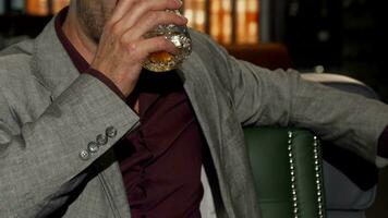 Handsome mature man smiling to the camera while drinking whiskey video