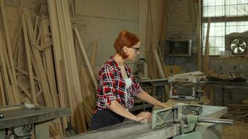 Female carpenter using power tools at her workshop video