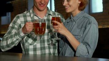 adorável casal abraçando enquanto bebendo Cerveja juntos às a restaurante video
