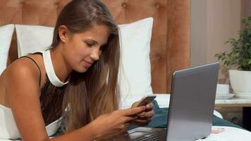 Happy beautiful woman using smartphone at the hotel room video