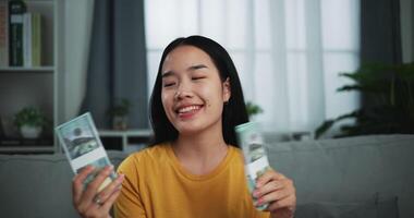 gelukkig jong Aziatisch Dames dollar trossen en verheugt eerste inkomen. video