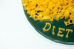 macaroni alphabet letters on a green plate. photo