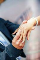 Groom wears bride a wedding ring on his finger. A couple betroth photo