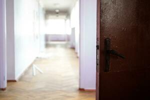 open dark door against light empty corridor of school. Ukrainian School during coronavirus quarantine. place for text. Copy space. school, education and learning concept photo