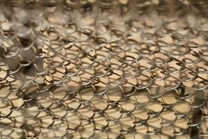 Mesh rabitz , texture of weaving mesh network link. Close up of a fence. barrier on way. metal grid close-up. rusty mesh texture photo