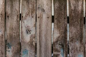 Old wooden fence with boards with slots photo