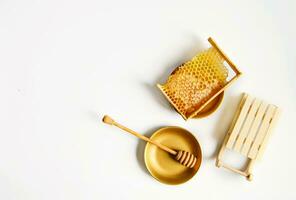 broken yellow honeycomb with honey on table next to decorative sleds. Honey products. healthy natural food concept. christmas and new year background for beekeeping photo