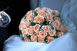 Bridal bouquet of pink roses on wedding photo