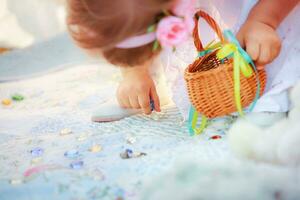 The child collecting colored clear stones to  basket. Festively photo