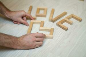 The word love built of wooden blocks on the floor photo