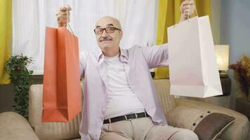 Man looking at camera with shopping bags. video