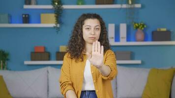 Young woman making stop sign for camera. video