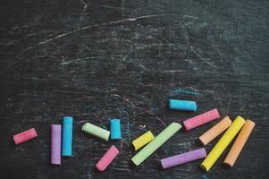 Multicolor chalk on backboard for education background photo