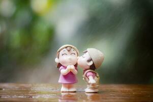 Close up of mini couple dolls in romantic kiss photo