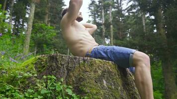Doing sit-ups in the forest, doing sports. video