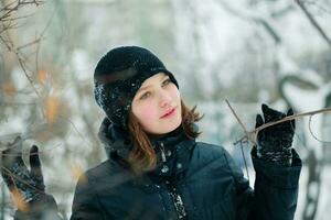 A beautiful girl spread the branches of a tree photo