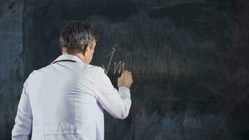 Male doctor writing Immunity on the blackboard. video