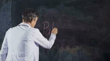 Male doctor writes Pathological on the blackboard. video