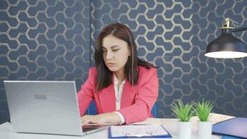 Young business woman relaxes after finishing her work on laptop. video