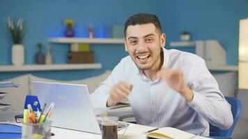 Home office worker man making cute gesture at camera. video